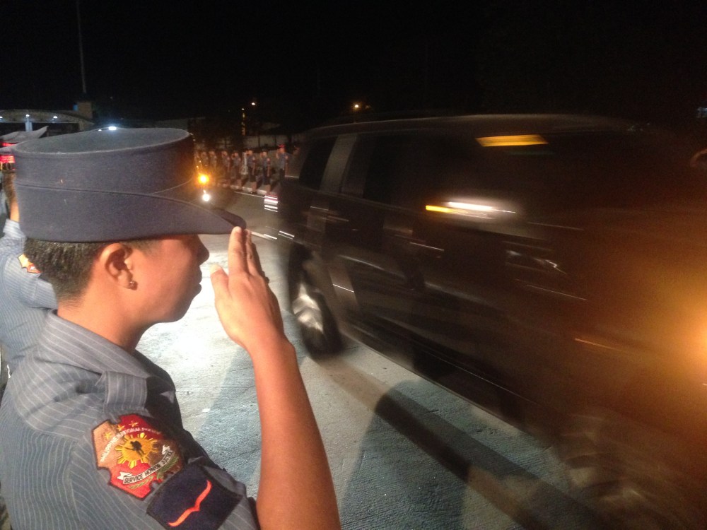 A policeman honoring the arrival of the closed caskets of the Fallen 44