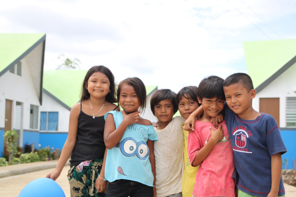 Smiling children replace construction workers. Now, they have a decent place to live.