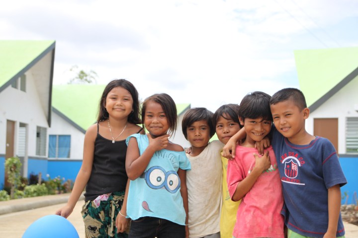 Smiling children replace construction workers. Now, they have a decent place to live.