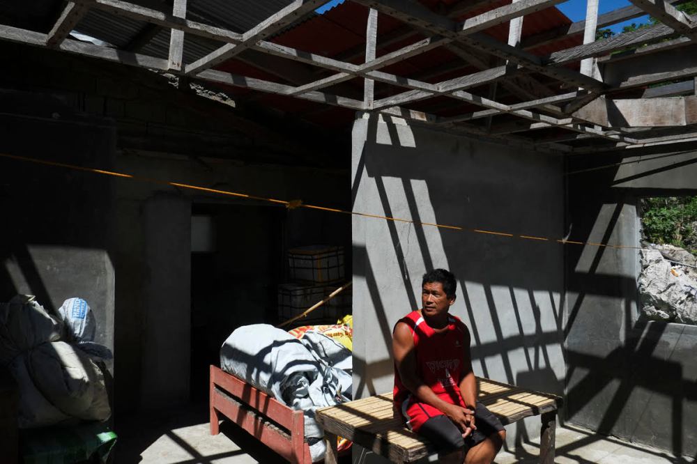 On that same rubber boat ride, we stopped by the first island of Gigantes where we met Mang Danilo. When typhoon Haiyan came, he decided to stay in the island while his family evacuated in a cave together with the rest of the community. On this picture he sits on what's left of his home. (Photo by VJ Villafranca)