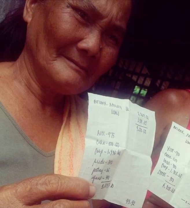 Lani, a sugar farmworker, shows her one dollar payslip for 15 days of work. (Photo from the National Federation of Sugar Workers)